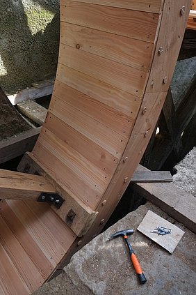 Abb. 7: Zuletzt werden die Schalbretter auf der Innenseite des Radkranzes gesetzt. Sie bilden die Böden der Kammern. Jedes Brett wird vernagelt. Foto: Leon Söllner