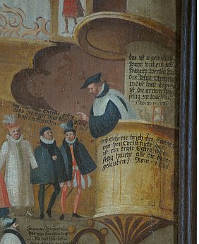 Neben dem Prediger auf der Kanzel steht eine kleine Sanduhr.