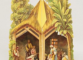 Die Krippe ist aus Papier. Sie wird gefaltet und aufgestellt. Sie zeigt die Geburt Christi. Der Stall ist mit Stroh gedeckt. Im Stall befinden sich mehrere Personen und Tiere.